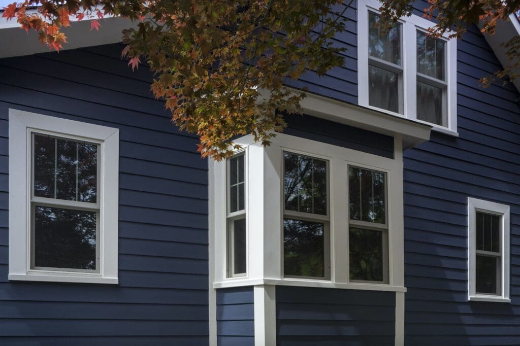 house with white trim and dark blue hardie siding