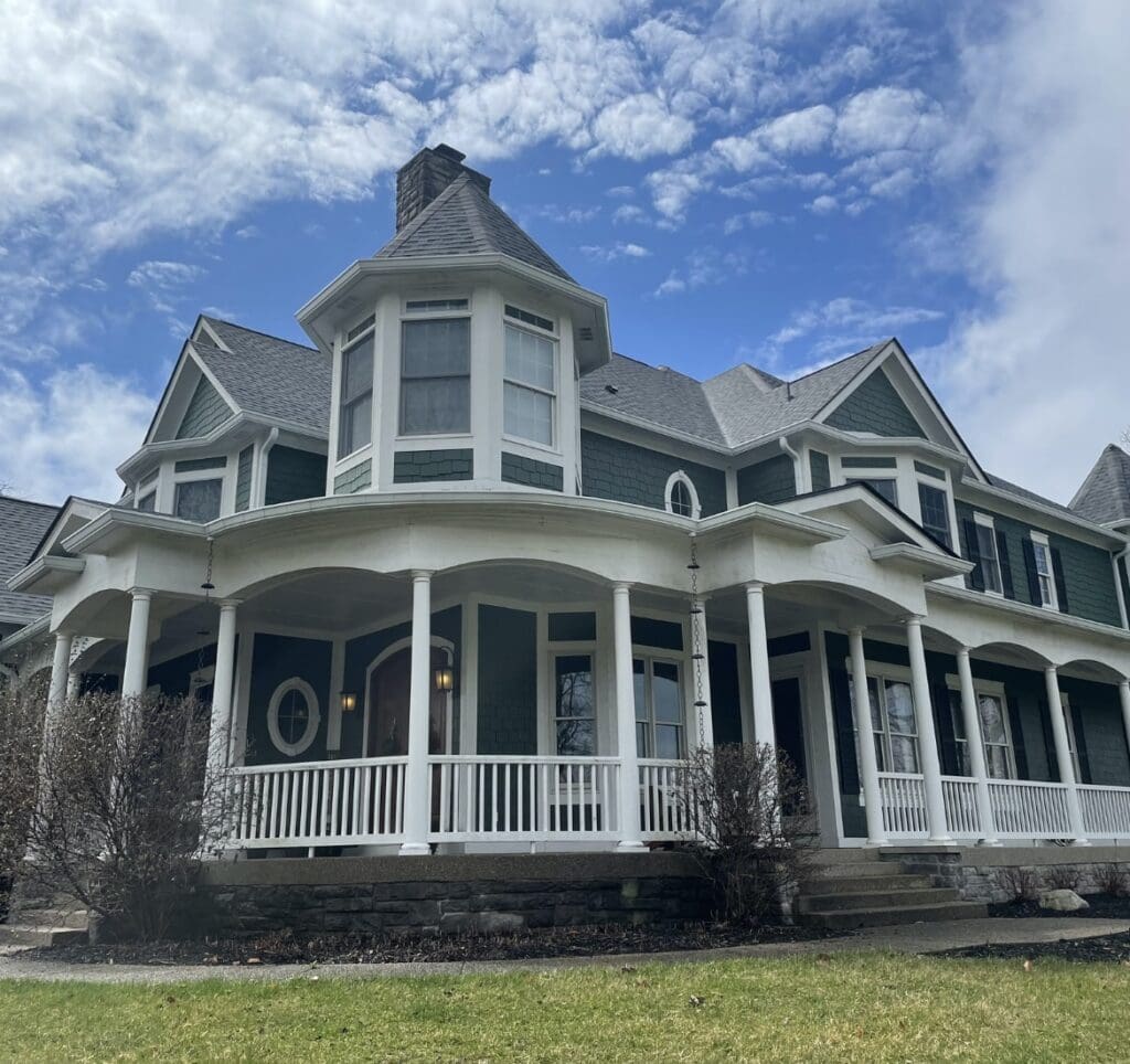 home with a wrap around porch with new James Hardie Board siding